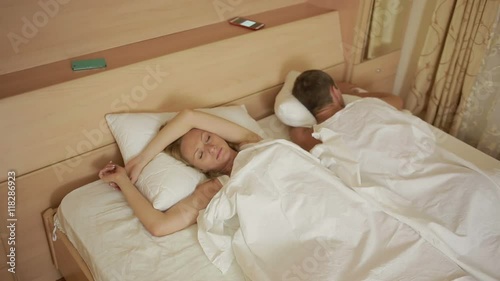girl looking phone partner while he sleeps. proof of infidelity photo