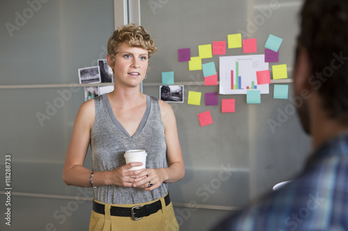 Businesswoman talking to colleague in office