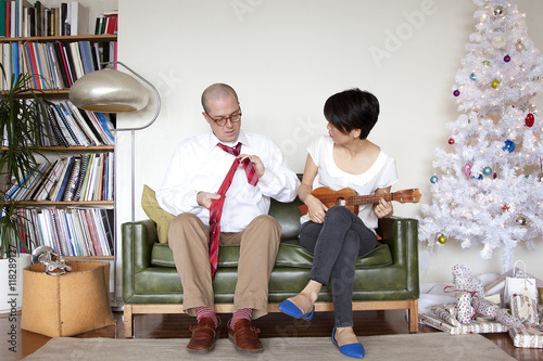 Couple enjoying gifts near Christmas tree photo