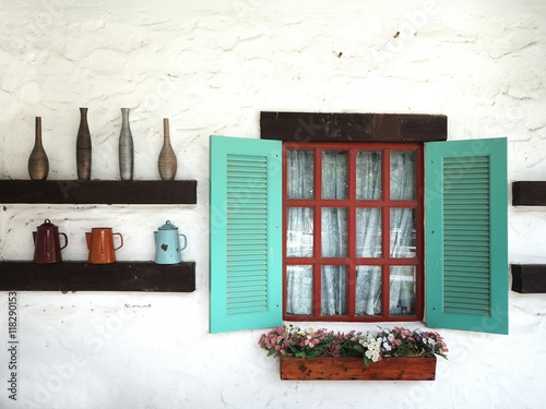 Vintage window Box on the white wall with colorful geranium