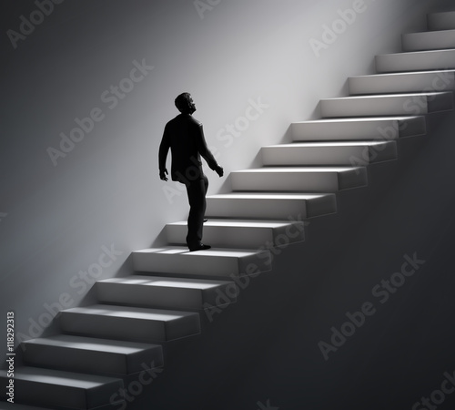 Man walking up the stairs towards light