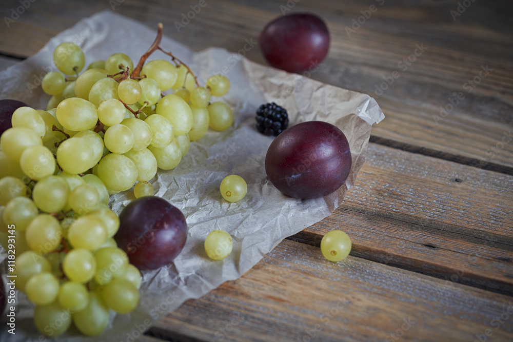 Mix of fresh berries and fruits on rustic wooden background Mix of fresh berries and fruits on rustic wooden background