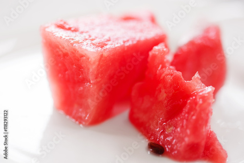 Slice of watermelon on white plate, close up photo