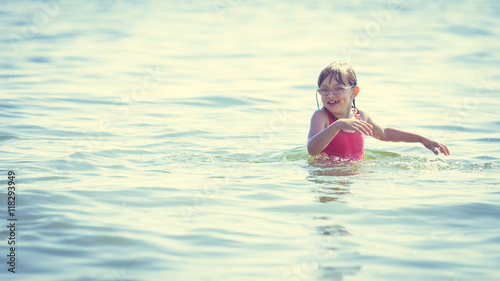 Little girl kid in sea water. Fun © Voyagerix