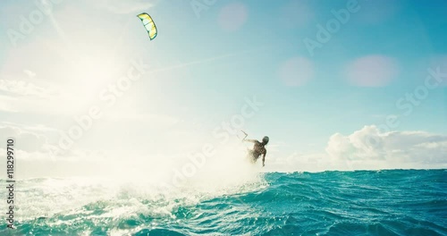 Beautiful young woman kiteboarding at sunset in slow motion, active lifestyle extreme sport