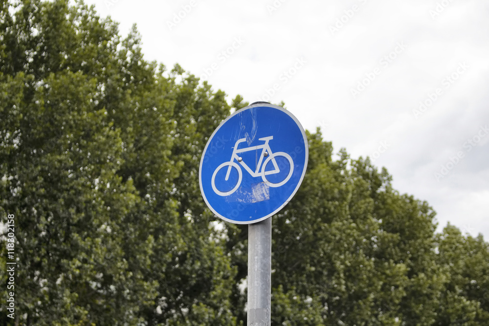 Bicycle traffic sign in BerlinBicycle traffic sign with background of trees in Berlin