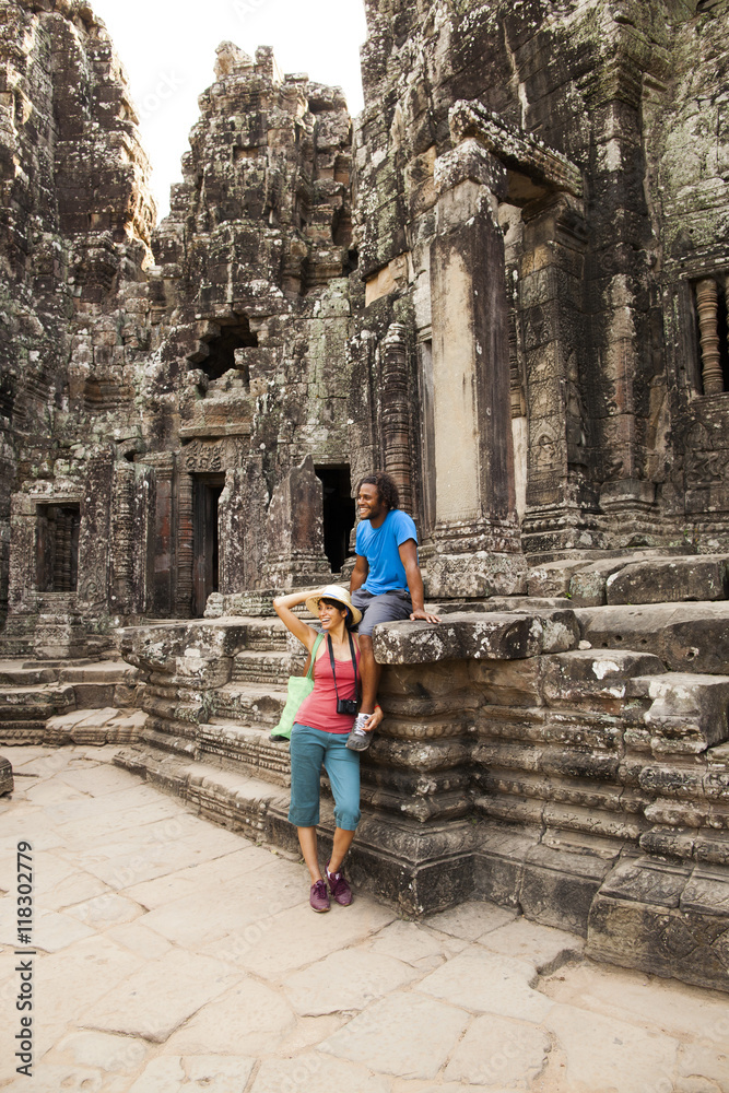 Couple visiting ancient temple, Angkor, Siem Reap, Cambodia Couple visiting ancient temple, Angkor, Siem Reap, Cambodia