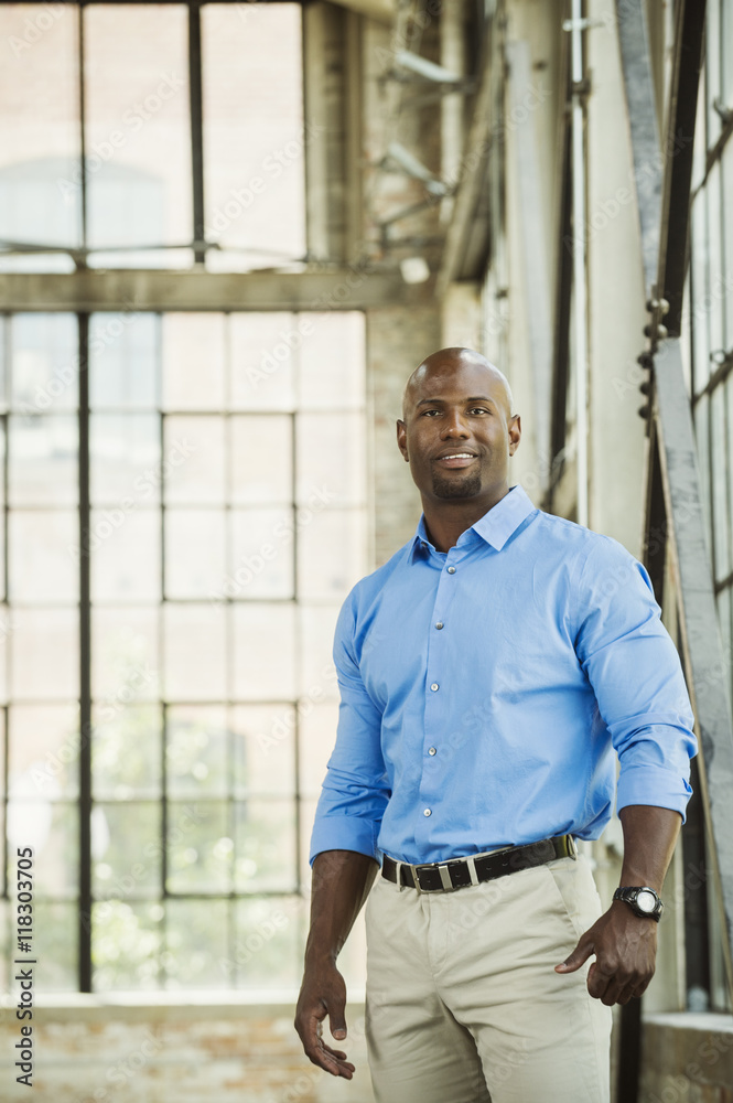 Black businessman smiling in warehouse Black businessman smiling in warehouse
