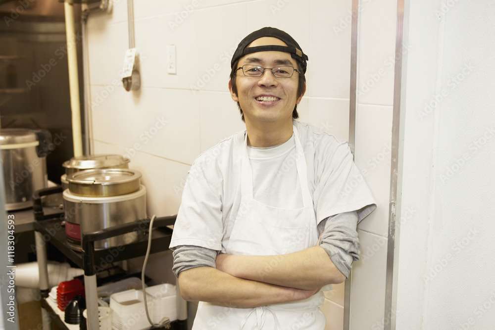 Japanese chef smiling in commercial kitchen Japanese chef smiling in commercial kitchen