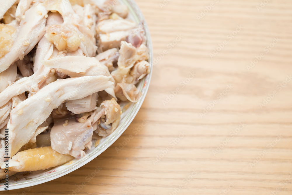 dish of shredded boiled chicken on wood table with copy space dish of shredded boiled chicken on wood table with copy space