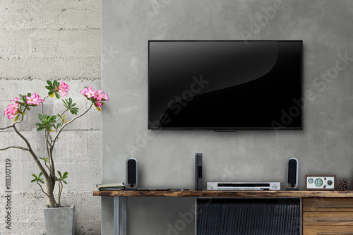 Led tv on concrete wall with wooden table in living room