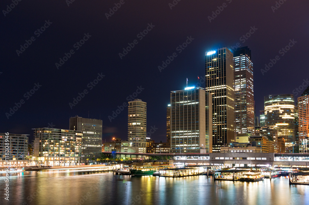 Circular Quay wharf with Sydney skyline at dusk. Modern cityscape and infrastructure, NSW, Australia