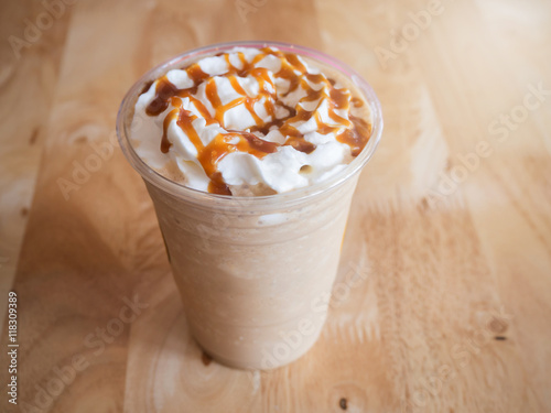 Coffee caramel frappe with whipped cream in a coffee shop