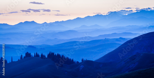 The sunset layers of mountains  vast background material.