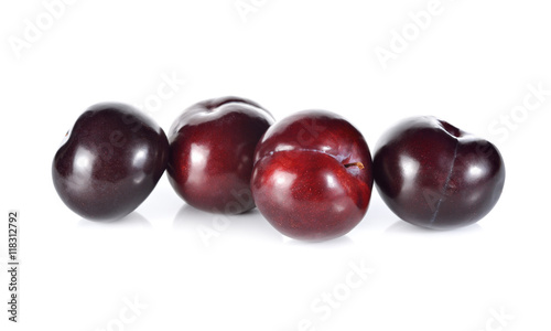 whole ripe plum on white background