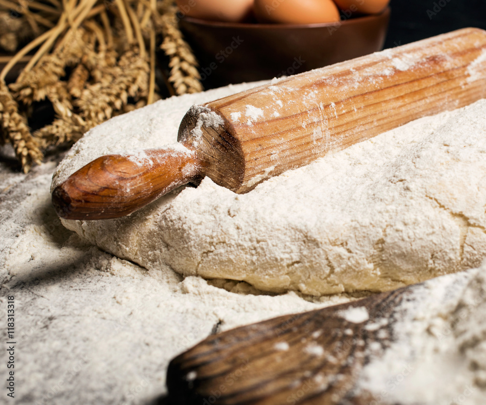 dough with wooden rolling pin on wooden table dough with wooden rolling pin on wooden table
