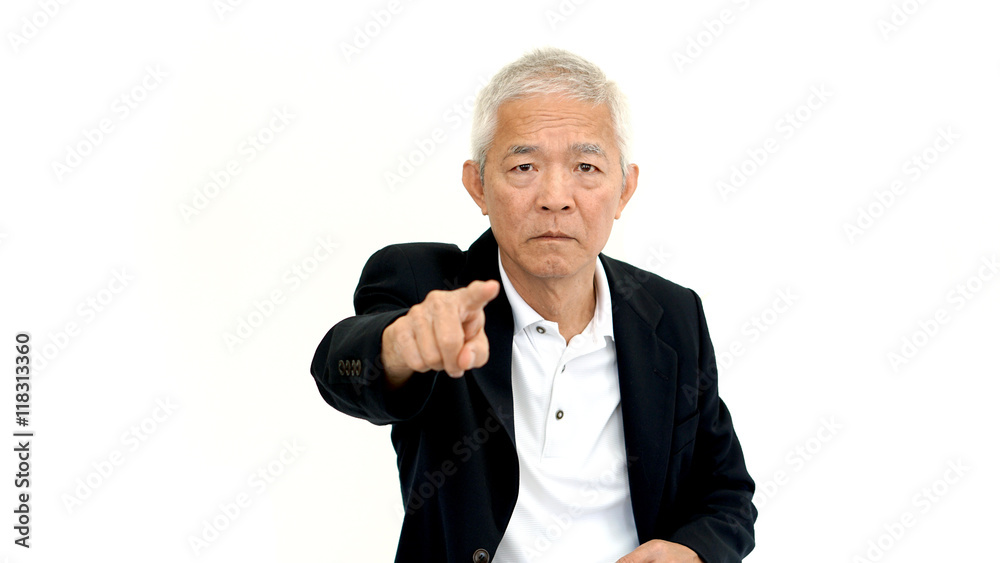 Asian senior business man wearing suit pointing with upset expre Asian senior business man wearing suit pointing with upset expre