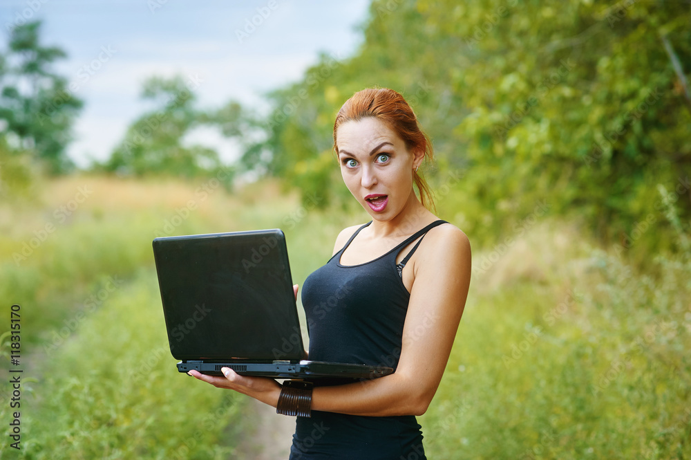 a young emotional girl with laptop in the Park a young emotional girl with laptop in the Park