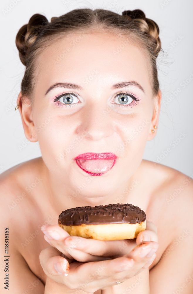 young woman in bright makeup eating a tasty donut with icing. Funny joyful woman with sweets, dessert. dieting concept. junk food. girl licking their fingers young woman in bright makeup eating a tasty donut with icing. Funny joyful woman with sweets, dessert. dieting concept. junk food. girl licking their fingers