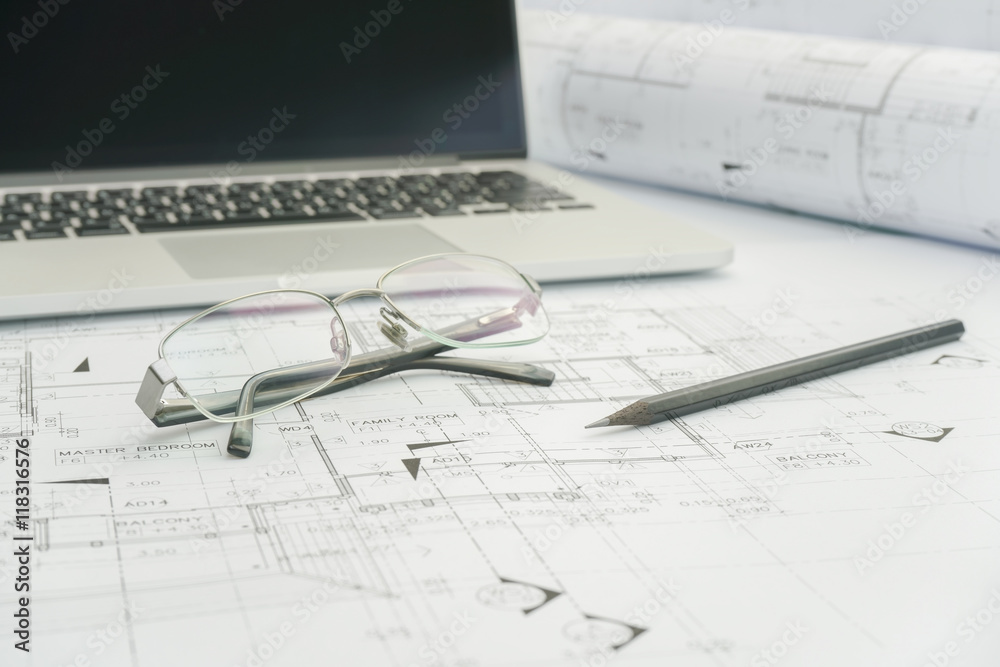 black pencil and computer laptop on architectural drawing paper for construction black pencil and computer laptop on architectural drawing paper for construction
