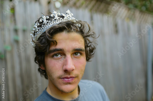 Hispanic man wearing crown in backyard photo