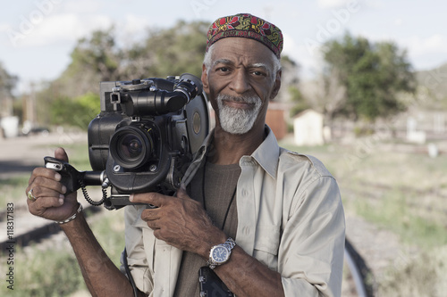 African American man using film camera photo