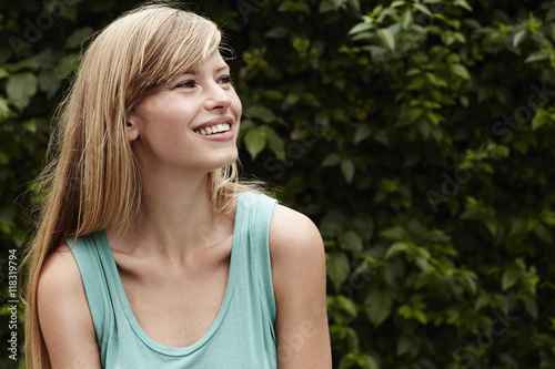 Smiling and gorgeous young blond woman, looking away