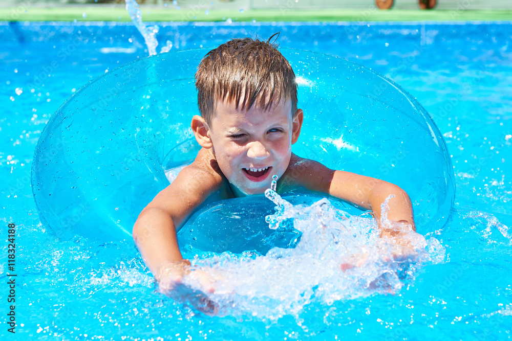 Boy swimming into pool