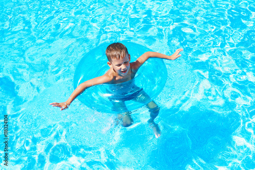 Boy swimming into pool
