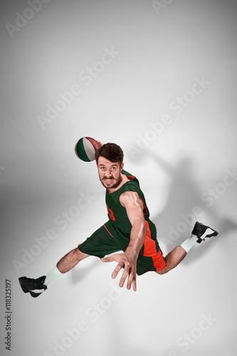 Full length portrait of a basketball player with ball