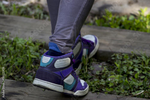 Girl wears comfortable shoes walking on railway road