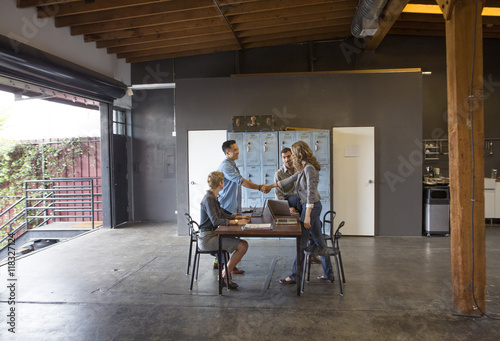 Business people shaking hands in office meeting