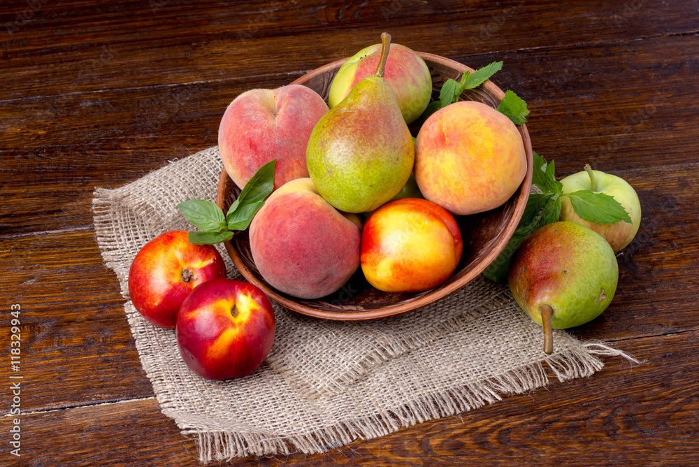 peaches, nectarines and pears - summer fruit on wooden background