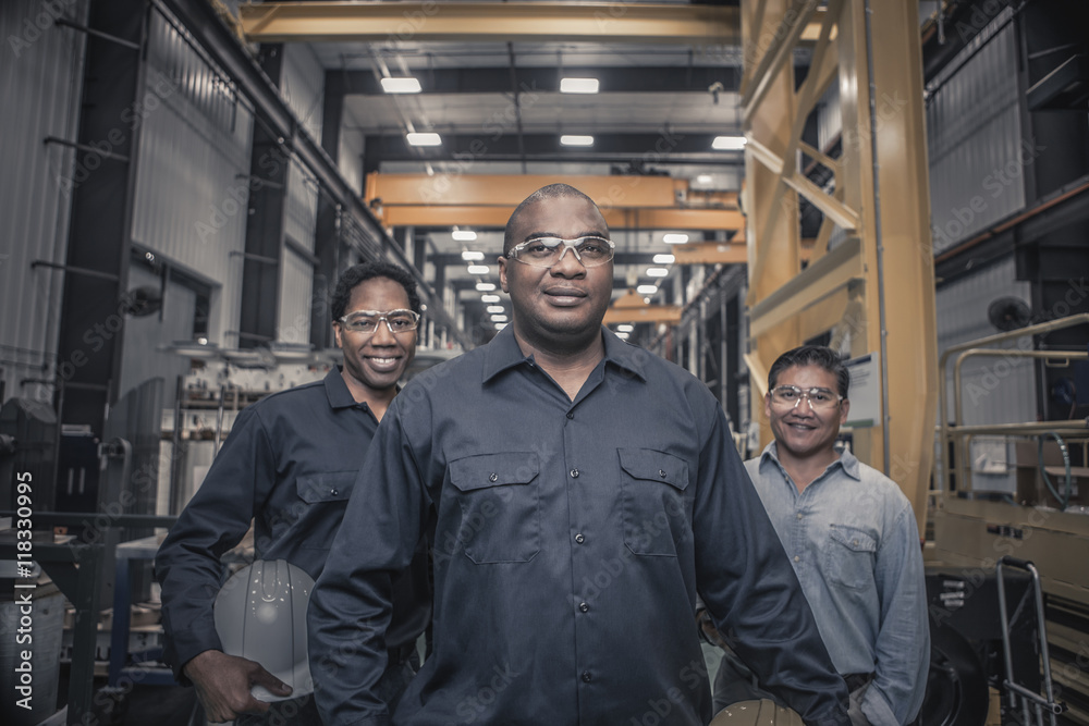 Workers standing together in factory Workers standing together in factory