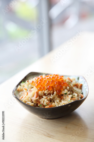 Japanese Cuisine Fried Rice with salmon and caviar on top photo