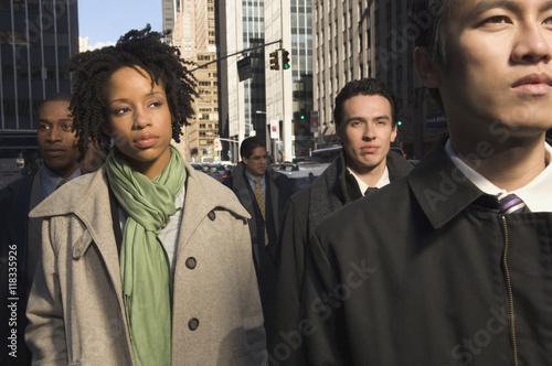 Multi-ethnic businesspeople in urban scene