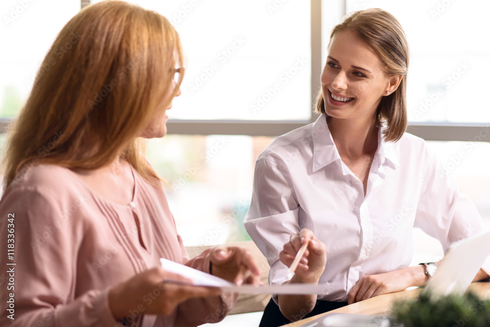 Cheerful smiling colleagues talking Cheerful smiling colleagues talking