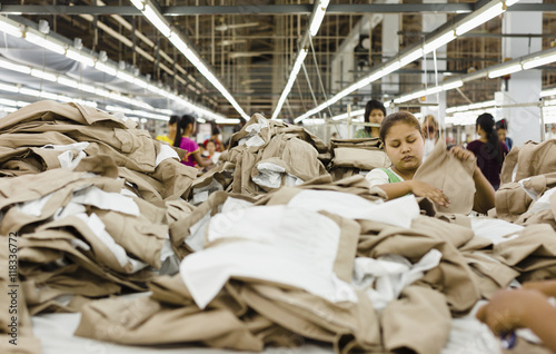 Workers folding clothing in garment factory