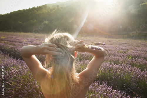 Caucasian woman admiring field of flowers photo