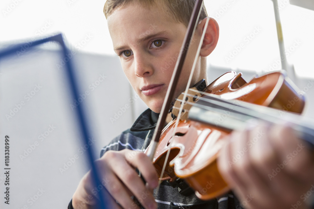 Close up of Caucasian boy playing violin Close up of Caucasian boy playing violin