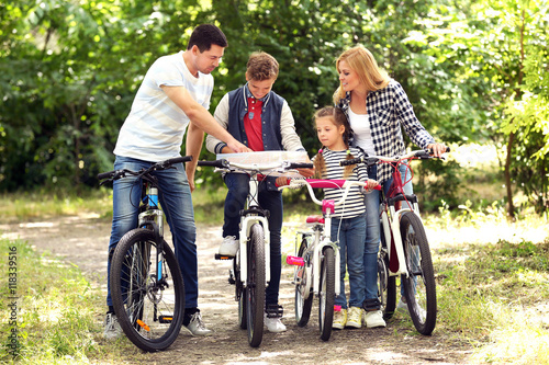 Happy family with map on bi...