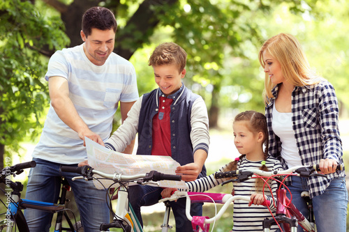 Happy family with map on bi...