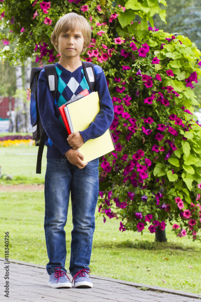 Little boy with a backpack go to school. Outdoor