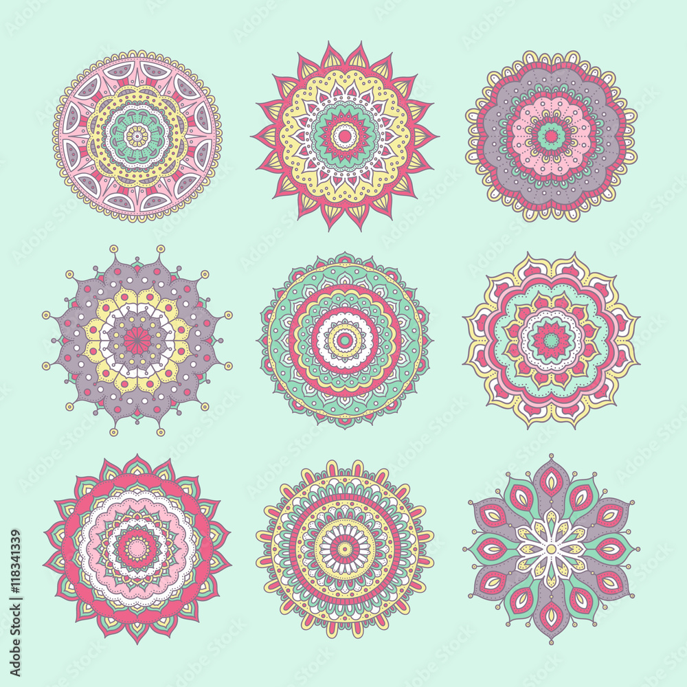 Set of colorful doodle mandalas. Circle lace ornament. Vector hand drawn ethnic floral pattern. Abstract tribal flowers set. Pastel color elements on light green background.