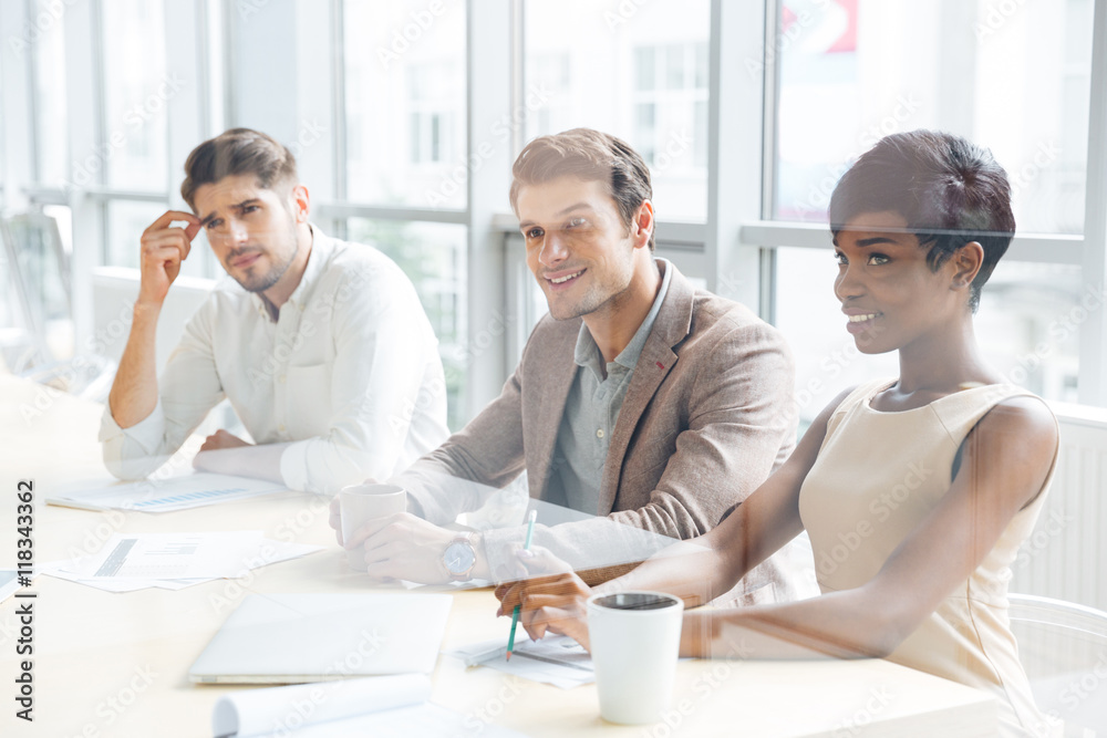 Business people sitting on training and making notes in office Business people sitting on training and making notes in office