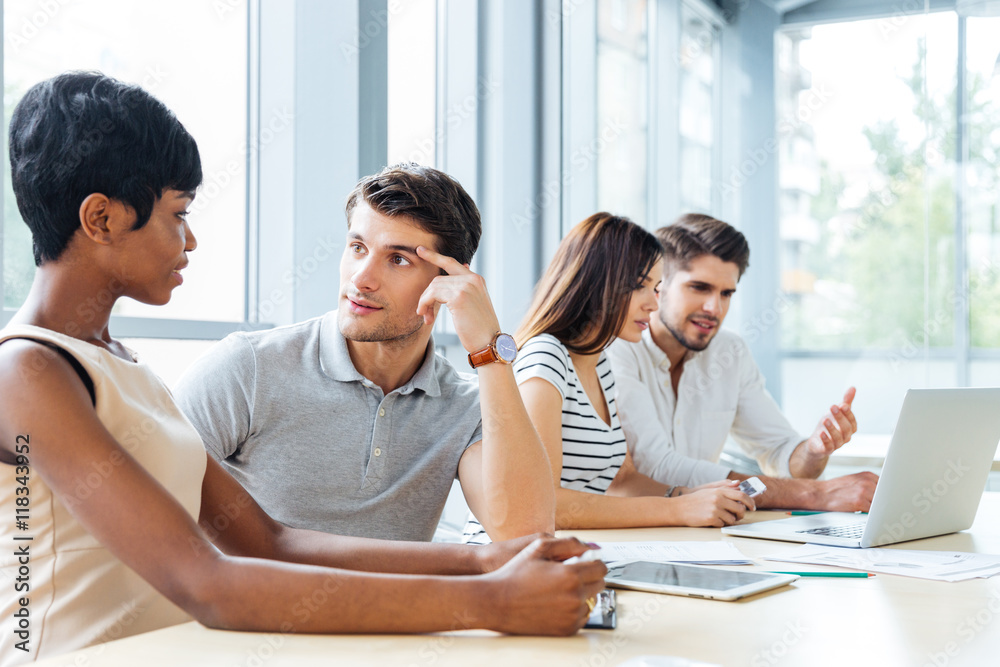 Business people sitting and talking in office Business people sitting and talking in office