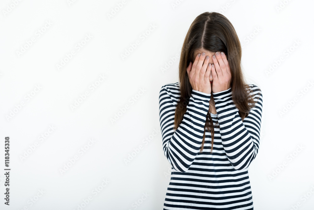 Girl covering her face with hands, embarressment, surprise, distress concept Girl covering her face with hands, embarressment, surprise, distress concept