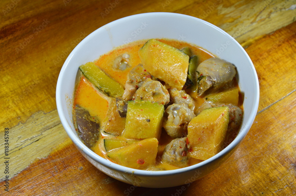 spicy pumpkin with chicken knees in coconut cream curry on bowl spicy pumpkin with chicken knees in coconut cream curry on bowl