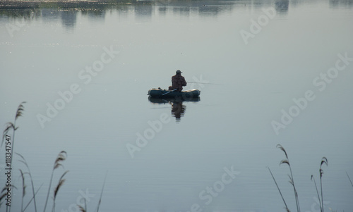 fisherman in boat . Man with spinning