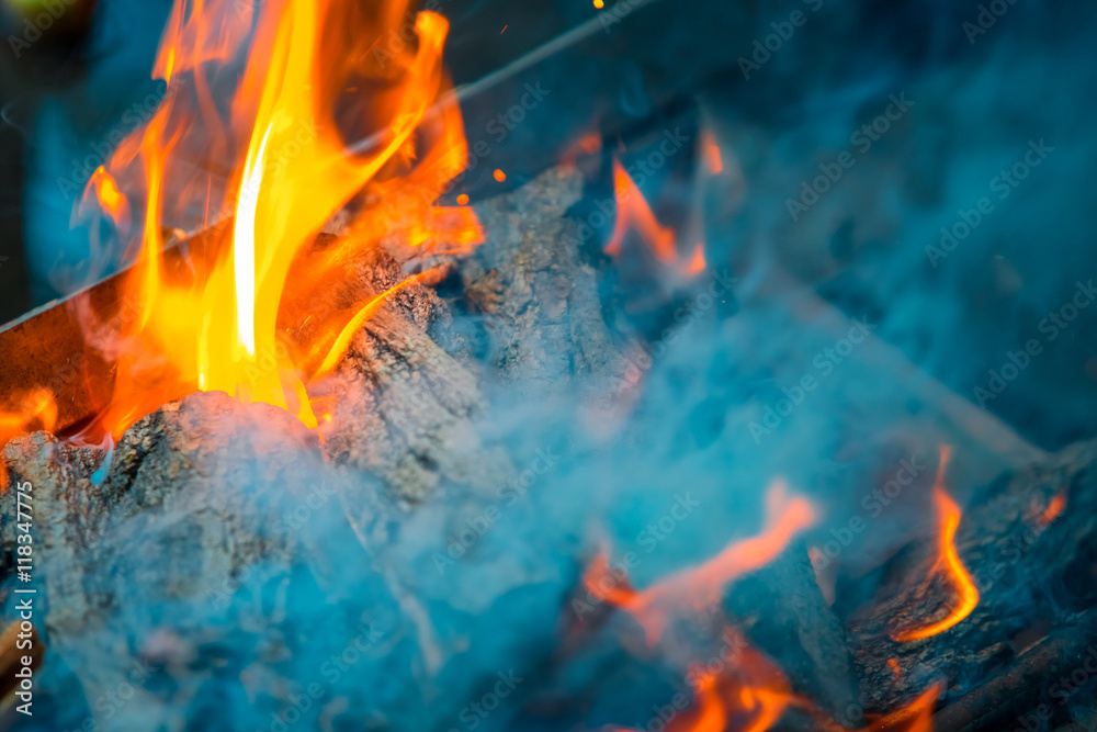 Fototapeta premium Beautiful burning fire flame background with smoke